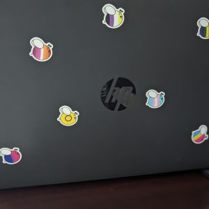 Pride Bee Mini Sticker Pack on a laptop
